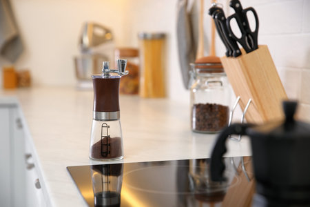 Manual coffee grinder on countertop in kitchenの写真素材