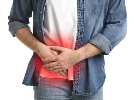 Man suffering from acute appendicitis on white background, closeupの写真素材