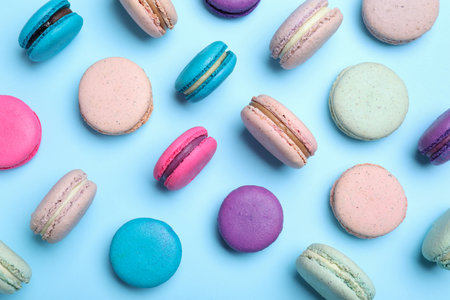 Delicious colorful macarons on light blue background, flat layの写真素材