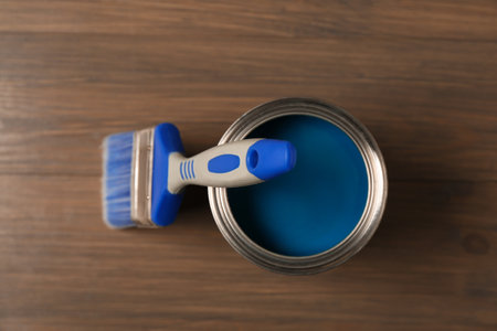Can of blue paint and brush on wooden background, top viewの写真素材