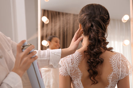 Stylist working with client in salon, making wedding hairstyleの写真素材