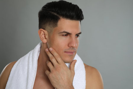 Handsome man after shaving on gray backgroundの写真素材