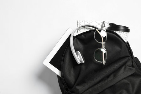 Stylish urban backpack with different items on white background, top viewの写真素材