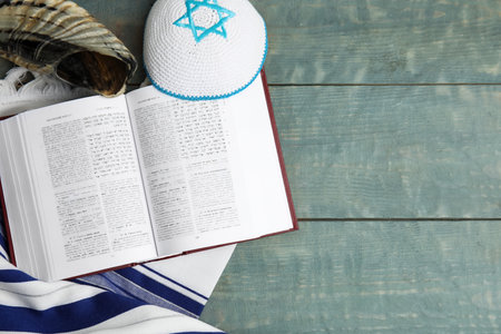 Flat lay composition with Rosh Hashanah holiday symbols on light blue wooden table. Space for textの写真素材