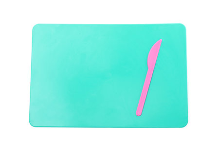 Turquoise board with knife for plasticine on white background, top viewの写真素材