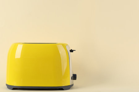 Modern toaster on beige background. Space for textの写真素材