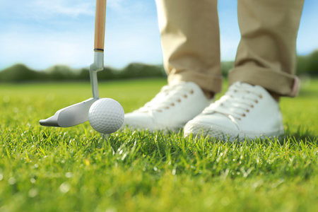 Person playing golf on green course, closeupの写真素材