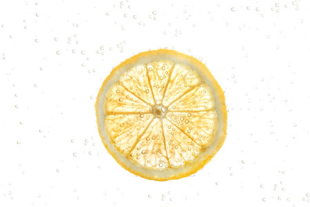 Slice of lemon in sparkling water on white background. Citrus sodaの写真素材