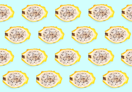 Cut delicious exotic dragon fruits on turquoise background, flat layの写真素材