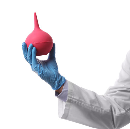 Doctor holding pink enema on white background, closeupの写真素材