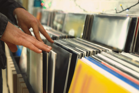 Man choosing vinyl records in store, closeup