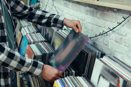 Man choosing vinyl records in store, closeupの写真素材