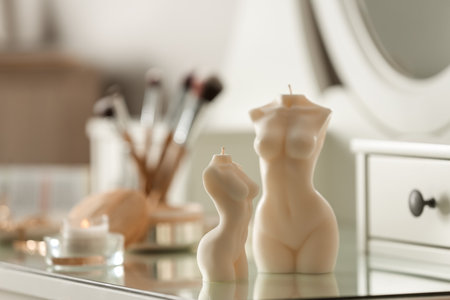 Beautiful body shaped candles on dressing table indoors, space for textの写真素材