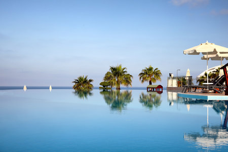 Beautiful landscape with blue sky and infinity pool at resortの写真素材