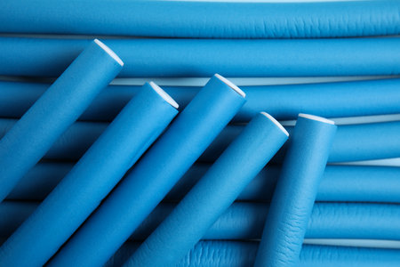 Curling rods as background, closeup. hair styling toolの写真素材