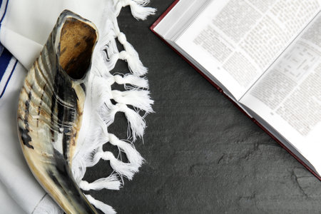 Tallit, shofar and open Torah on black table, flat lay. Rosh Hashanah celebrationの写真素材