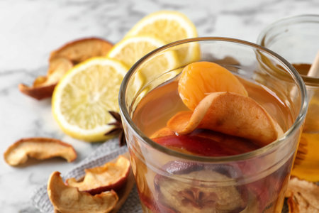 Delicious compote with dried fruits in glass on table, closeup. Space for textの写真素材