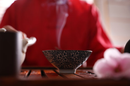Steam raising above cup on tray. traditional tea ceremonyの写真素材