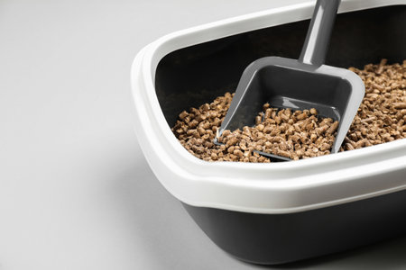 Cat litter tray with filler and scoop on light background, closeupの写真素材