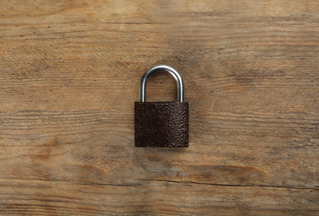 Modern padlock on wooden table, top viewの写真素材