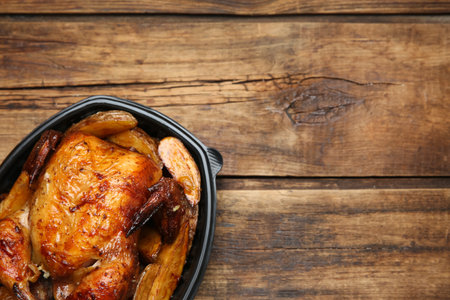 Top view of delicious grilled chicken with potato in plastic container on wooden table, space for text. food delivery serviceの写真素材