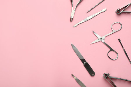 Set of manicure tools on pink background, flat lay. Space for textの写真素材