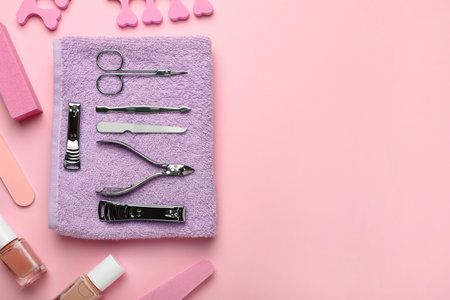 Set of manicure tools and accessories on pink background, flat lay. Space for textの写真素材