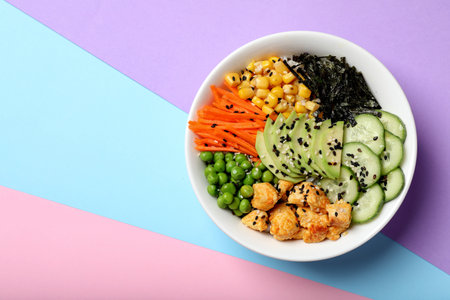 Delicious salad with chicken and vegetables on color background, top view. Space for textの写真素材