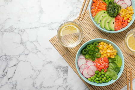 Delicious salad with salmon and vegetables served on white marble table, flat lay. Space for textの写真素材