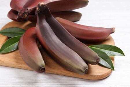 Tasty red baby bananas on white table, closeupの写真素材