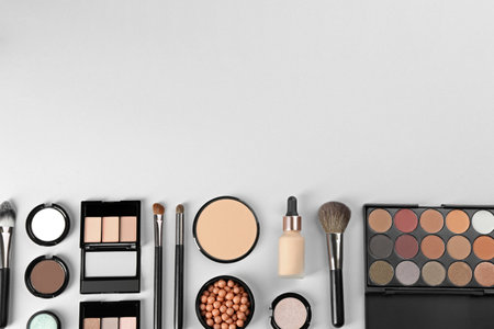 Flat lay composition with makeup brushes on light background, space for textの写真素材