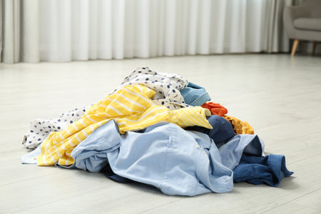Pile of dirty clothes on floor indoorsの写真素材