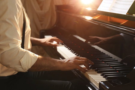 Man playing piano indoors, closeup. talented musicianの写真素材