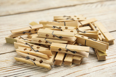Pile of clothes pins on white wooden table, closeupの写真素材