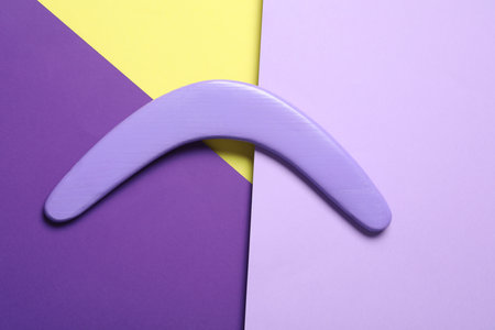 Lilac wooden boomerang on color background, top viewの写真素材