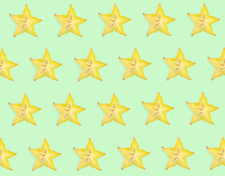 Slices of carambola on light green background, flat layの写真素材