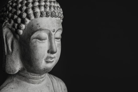 Beautiful stone Buddha sculpture on black background, closeup. Space for textの写真素材