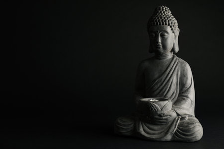 Beautiful stone Buddha sculpture on black background. Space for textの写真素材