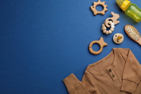 Flat lay composition with baby clothes and accessories on blue background, space for textの写真素材