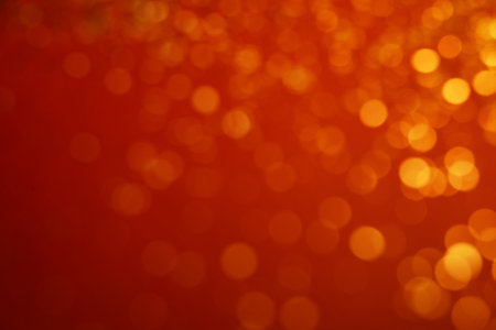 Blurred view of golden lights on red background. bokeh effectの写真素材