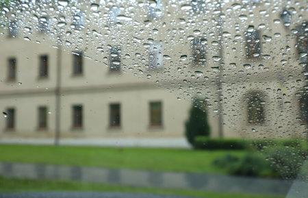 Blurred view of city street through wet car window. rainy weather