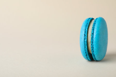 Delicious light blue macaron on beige background. Space for textの写真素材