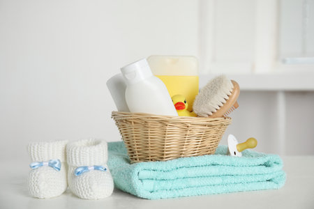 Baby booties and accessories on white table indoorsの写真素材