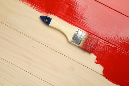 Brush on red painted wooden surface, top view. Space for textの写真素材