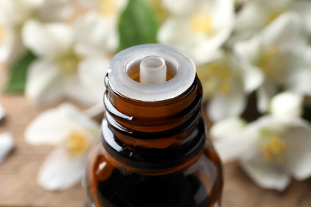 Bottle of natural jasmine essential oil on table, closeupの写真素材