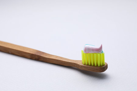 Wooden brush with toothpaste on white background, closeupの写真素材