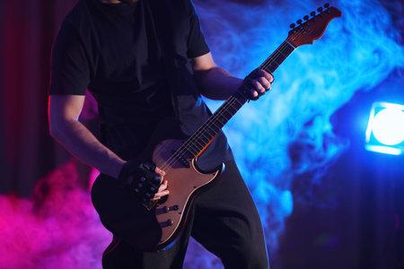Man playing electric guitar on stage, closeup. rock musicの写真素材
