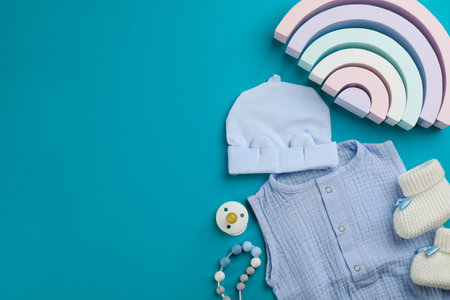 Flat lay composition with baby clothes and accessories on light blue background, space for textの写真素材