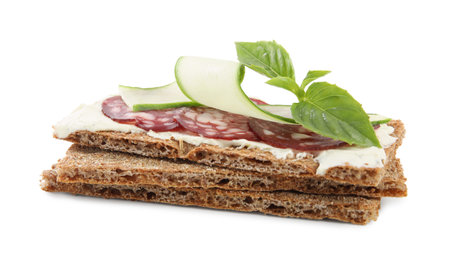 Fresh rye crispbreads with salami, cream cheese and cucumber on white backgroundの写真素材