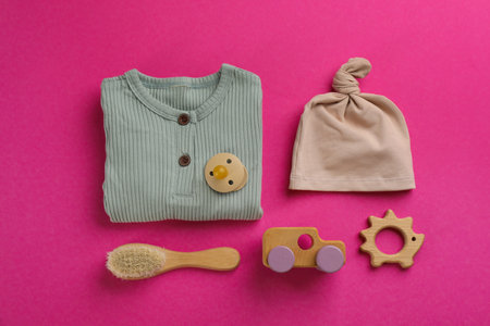 Flat lay composition with baby clothes and accessories on pink backgroundの写真素材